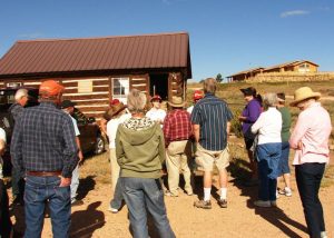 Tour participants getting info at Robinson Cabin